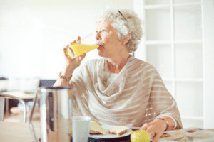 older woman drinking juice