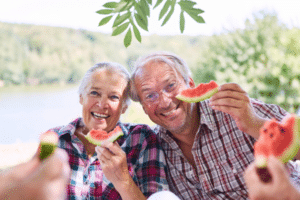senior couple eating watermelon