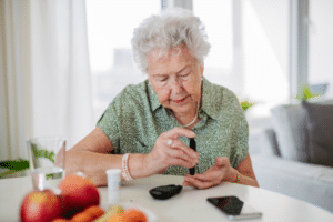 senior woman checking blood sugar