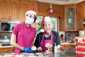 Caregiver and client with Santa hats