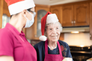 Nurse Next Door Caregiver and client in Santa hats
