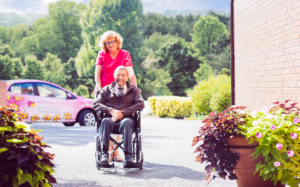 Nurse Next Door caregiver and veteran client in a wheel chair
